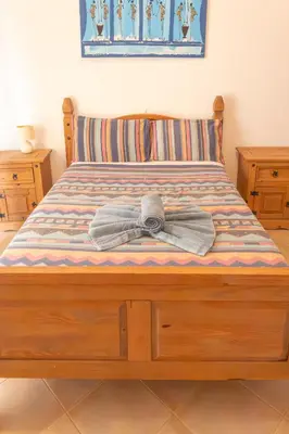 a bed with a bow on top of it at Santa Maria Residence in Santa Maria