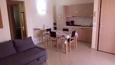a kitchen with a table and chairs and a couch at Brito Place in Santa Maria