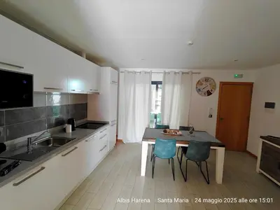 a kitchen with a table and chairs in a kitchen at Albis Harena - In Sal in Santa Maria