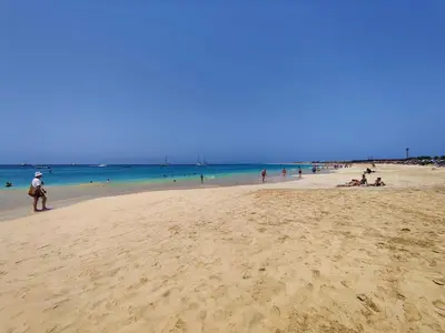 a group of people on a beach with the ocean at Albis Harena - In Sal in Santa Maria