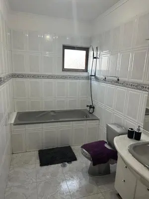 a bathroom with a tub and a toilet and a sink at Appartement avec Vue sur Mer à Praia, Wi-Fi, Navette Aéroport avec supplément in Praia