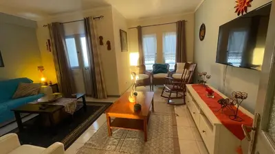 a living room with a couch and a tv at Girassol Tarrafal Apartment in Tarrafal