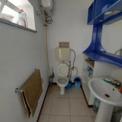 a small bathroom with a toilet and a sink at FeliGrab in Mindelo