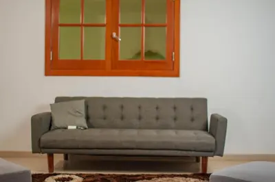 a couch in a living room with a cabinet at Cidade Serena in Cidade Velha