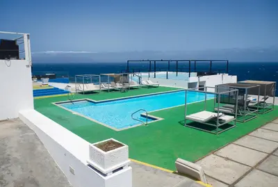 a swimming pool on the side of a building at The View Hotel CV in São Filipe