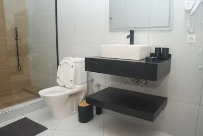 a bathroom with a toilet and a sink and a shower at The View Hotel CV in São Filipe