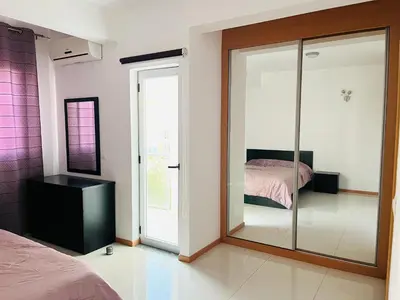a bedroom with a glass door with a bed at Douceur de Vie in Praia