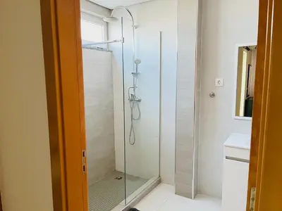 a shower with a glass door in a bathroom at Douceur de Vie in Praia