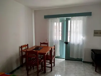 a dining room with a wooden table and chairs at Paraiso 162E in Santa Maria