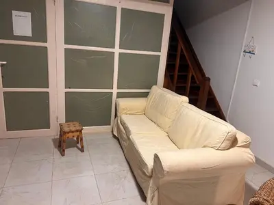 a living room with a white couch and a table at Paraiso 162E in Santa Maria