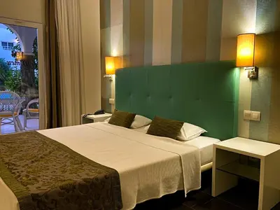 a bedroom with a large bed with a green headboard at Ouril Pontao Hotel in Santa Maria