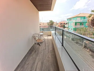 a balcony with a table and chairs on it at Casa Emilie T2, 2 bedrooms in Santa Maria