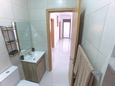 a bathroom with a sink and a toilet and a mirror at Casa Emilie T2, 2 bedrooms in Santa Maria