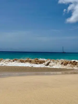 a sandy beach with a boat in the ocean at Studio with pool in Santa Maria