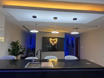 a kitchen with a sink and a counter with chairs at N3XT-LEVEL Pool in Praia