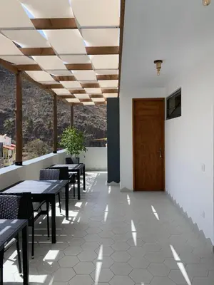 a restaurant with tables and chairs and a wooden door at Alfa-Rooms in Paul