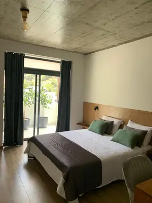 a bedroom with a large bed and a large window at Alfa-Rooms in Paul