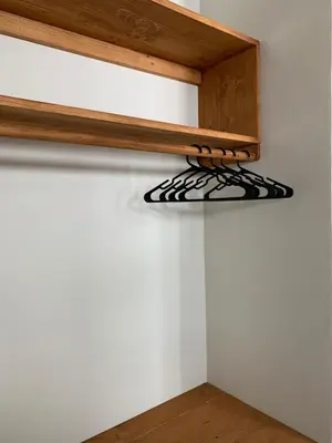 a shelf on top of a white wall at Alfa-Rooms in Paul