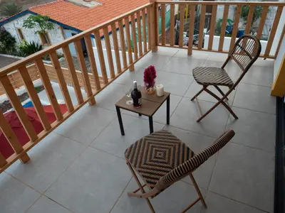 a balcony with a table and two chairs and a table and chairs at Blue Coast Villas - Villa 6 in Cidade Velha