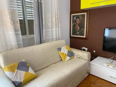 a living room with a couch and a television at Apartamento em Monte in Mindelo