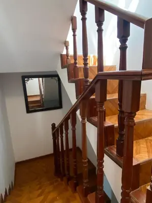 a wooden staircase with a mirror on the wall at Apartamento em Monte in Mindelo