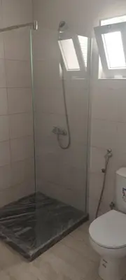 a bathroom with a glass shower with a toilet at Mira Mar Mindelo in Mindelo