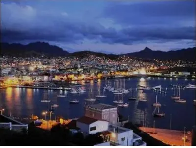 a harbor with boats in the water at night at Mira Mar Mindelo in Mindelo