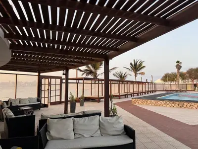 a patio with couches and a pool and a wooden pergola at Murdeira V17 I by RPG Group in Beirona