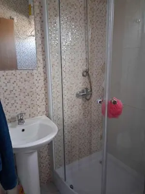 a bathroom with a shower and a sink at Casa da Sara Guest House in Mindelo