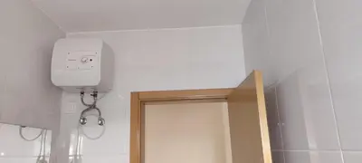 a bathroom with a shower with a camera on the wall at Sams House in Espargos