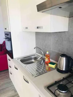 a kitchen counter with a sink and a stove at Kite & Chill Sal Rei in Sal Rei