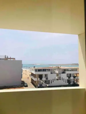 a view of the beach from the balcony of a building at Kite & Chill Sal Rei in Sal Rei