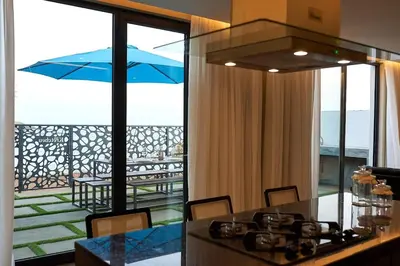 a kitchen with a view of a patio with an umbrella at CORAL BAY - Kode Villa in Cidade Velha
