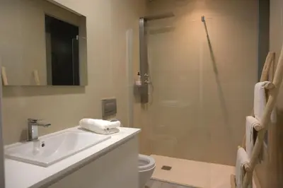 a bathroom with a toilet and a sink and a shower at CORAL BAY - Kode Villa in Cidade Velha