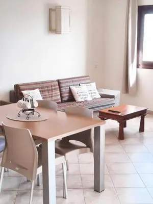 a living room with a table and a couch at HostySpot - Tropical Resort in Santa Maria