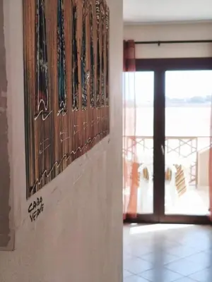 a room with a door and a window with a view of the ocean at HostySpot - Tropical Resort in Santa Maria