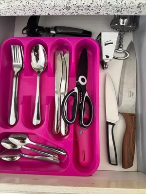 a pink plastic tray with utensils on a counter at Murdeira V 17 J by RPG Group in Beirona