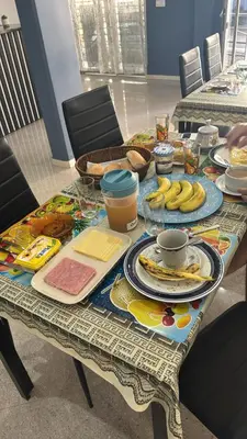 a table with plates of food and bananas on it at Pensao Restaurante Recanto in Tarrafal