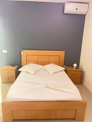 a bedroom with a large bed with a blue wall at Pensao Restaurante Recanto in Tarrafal