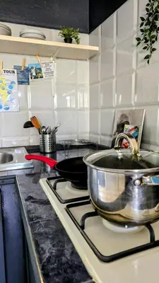 a kitchen with a sink and a pot on a stove at Celina's Cozy Studio & Beach Life in One in Santa Maria
