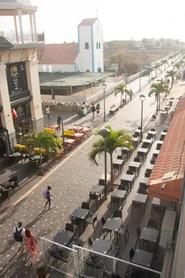 a street with tables and chairs on a city street at Doce de Sal in Santa Maria