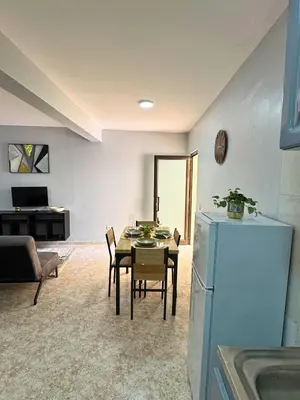 a kitchen and living room with a table and chairs at Doce de Sal in Santa Maria