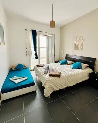 two beds in a bedroom with blue pillows at Surfing Ocean View Appartment in Sal Rei