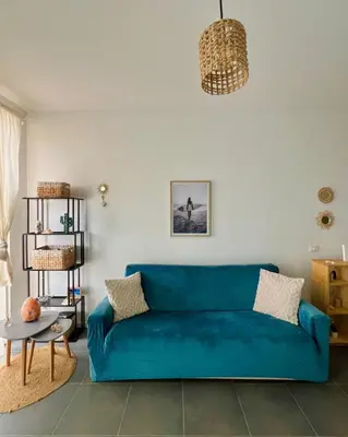 a living room with a blue couch and a table at Surfing Ocean View Appartment in Sal Rei