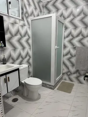 a bathroom with a toilet and a shower and a sink at Appartement Praia Sao Felipe in Praia