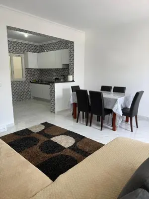 a kitchen and dining room with a table and chairs at Appartement Praia Sao Felipe in Praia