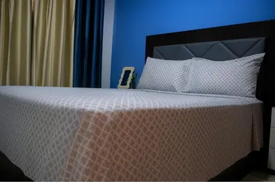 a bedroom with a bed with a blue wall at Cantinho dos Dias in Espargos