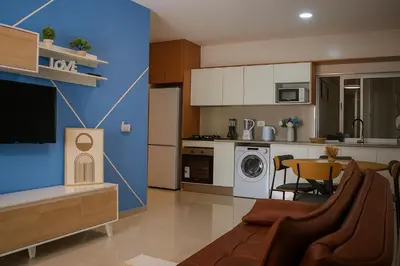 a living room with a couch and a kitchen at Cantinho dos Dias in Espargos