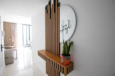 a mirror and a plant on a shelf in a room at Suncent apartment in Mindelo