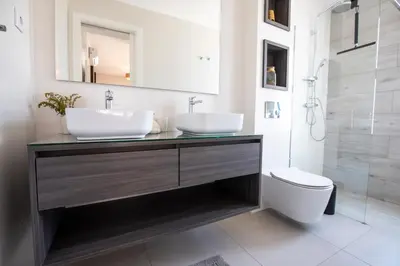 a bathroom with two sinks and a toilet at Suncent apartment in Mindelo